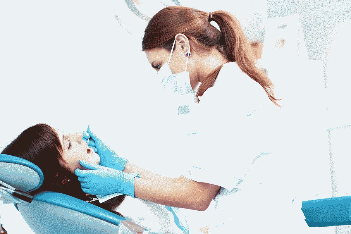 A young female dentist working in her office.